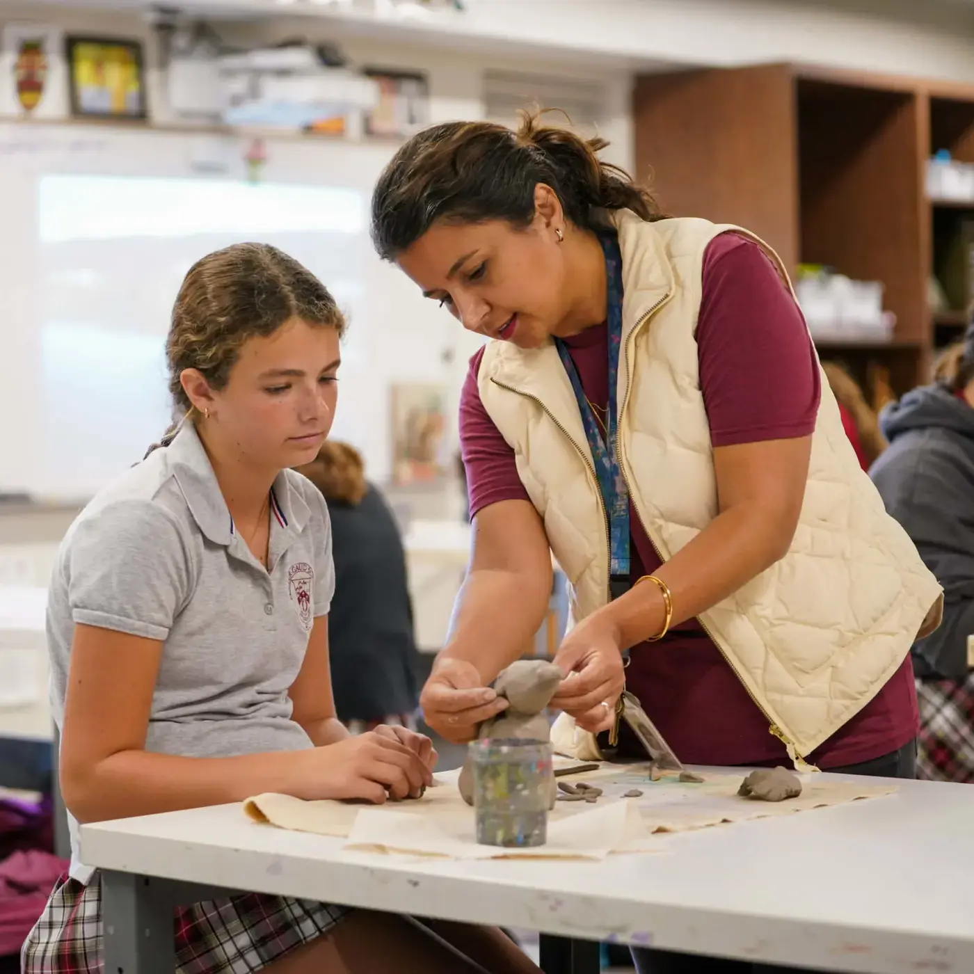 Porter-Gaud teacher helps student in an art class