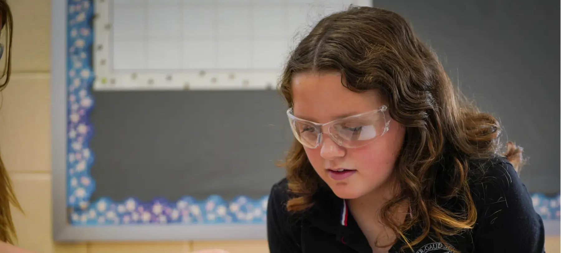 Porter-Gaud student performs an experiment in science class